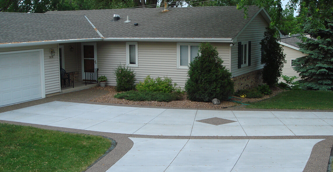 concrete driveway with parking pad