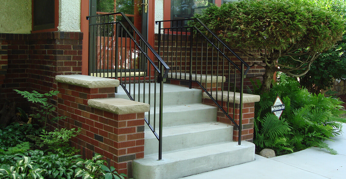 concrete entrance steps with brick buttresses